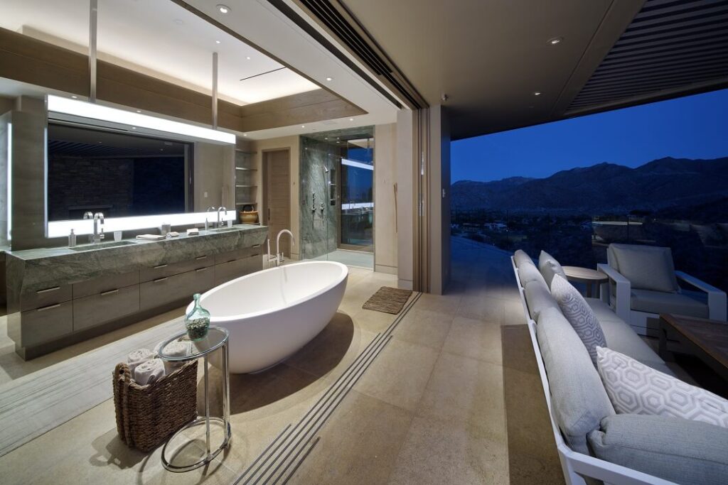 freestanding bathtub at sunset overlooking the mountains