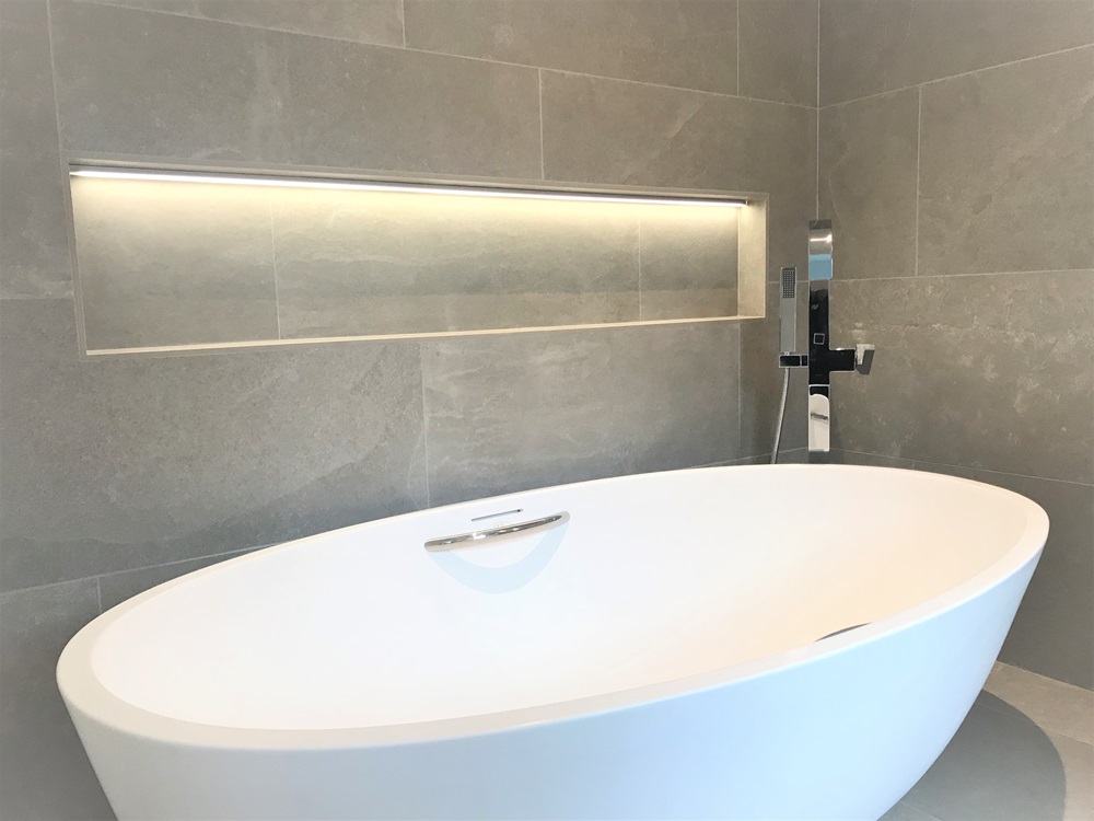 can you install a freestanding bathtub against a wall